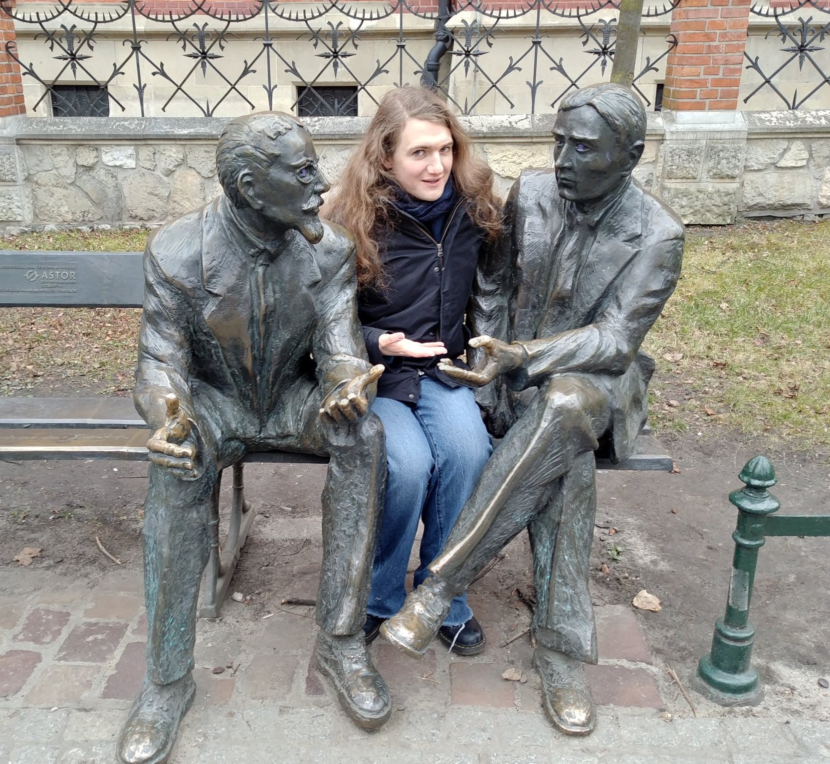 Picture of me sitting on a bench between statues of Banach and Nikodym, in Krakow.